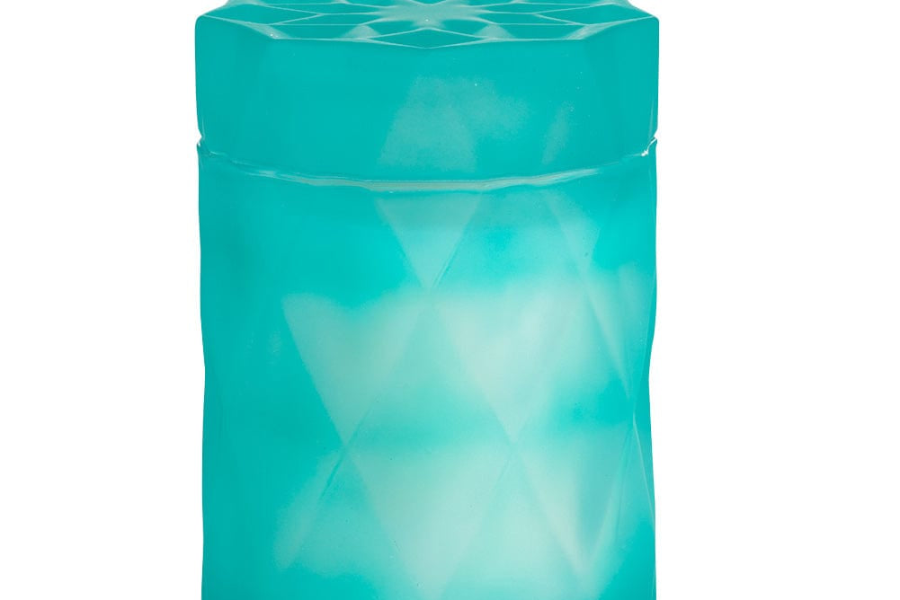 coconut wax candle in a light teal color glass jar with lid