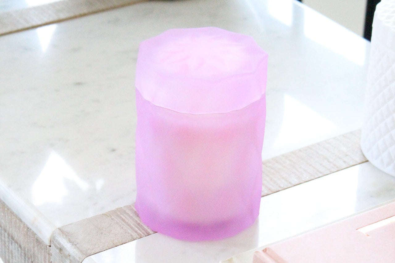 lavender lilac color glass jar with lid on a marble side table