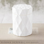 candle in a matte white glass jar with lid and diamond glass etching design