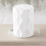 candle in a matte white glass jar with lid and diamond glass etching design