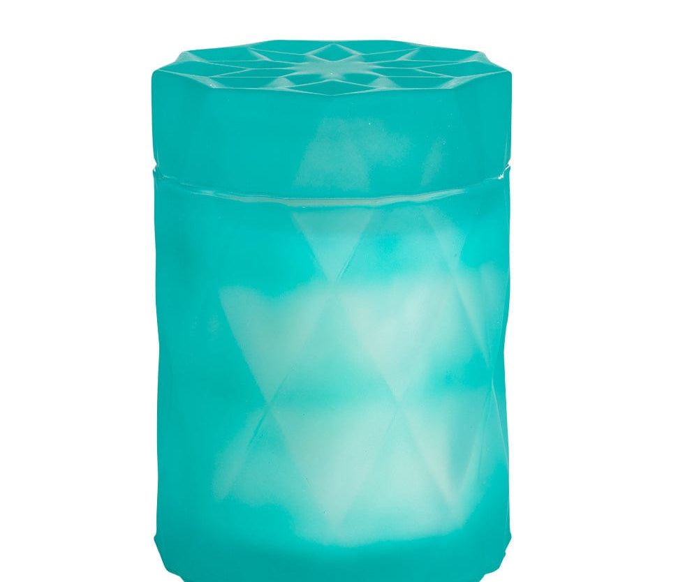 coconut wax candle in a light teal color glass jar with lid